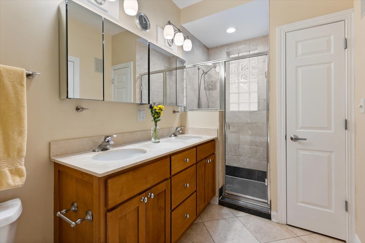 1249 North Wolcott Avenue, Unit 2 Chicago, IL 60622 - Photo 17 of 26 a bathroom with a sink a toilet and mirror