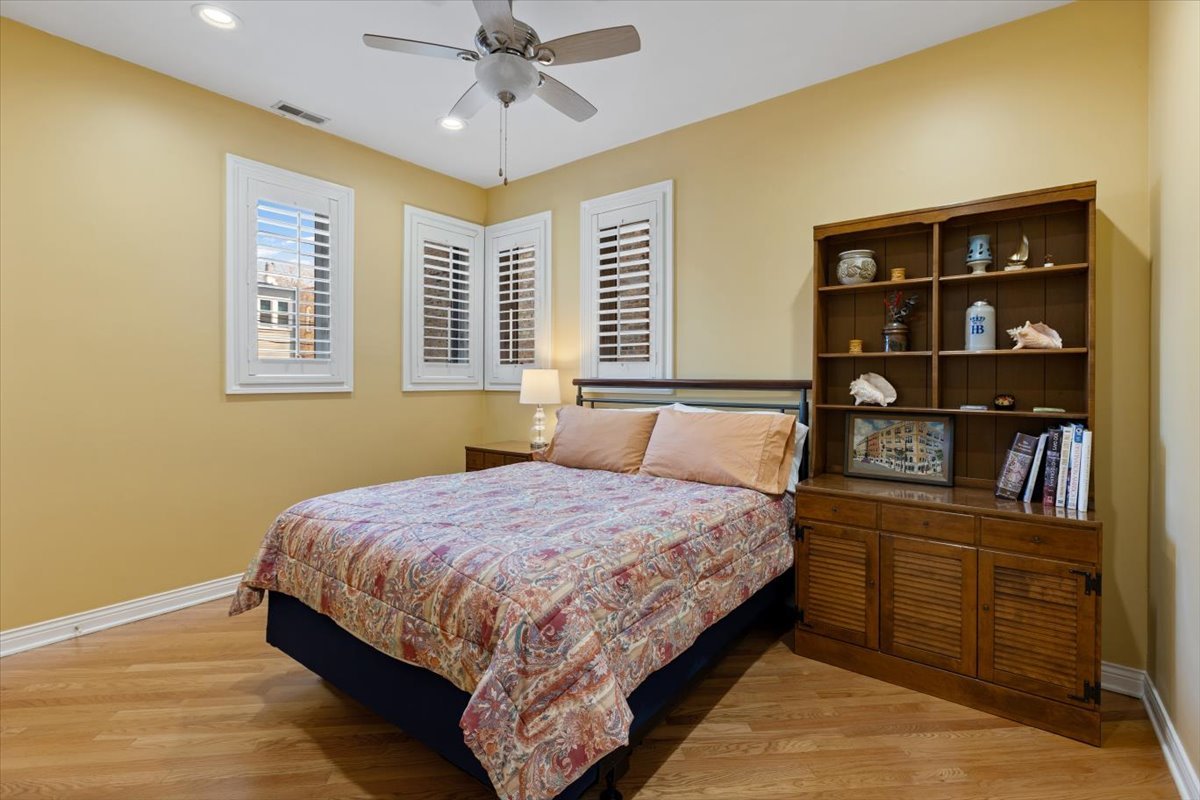 1249 North Wolcott Avenue, Unit 2 Chicago, IL 60622 - Photo 19 of 26 a bedroom with a bed cabinets and window