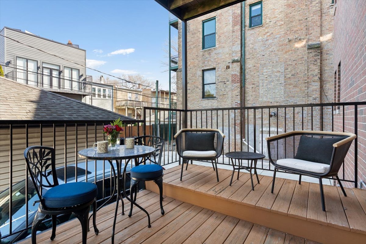 1249 North Wolcott Avenue, Unit 2 Chicago, IL 60622 - Photo 25 of 26 a roof deck with chairs and wooden floor