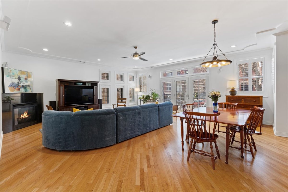 1249 North Wolcott Avenue, Unit 2 Chicago, IL 60622 - Photo 3 of 26 a living room with furniture a dining table and a flat screen tv