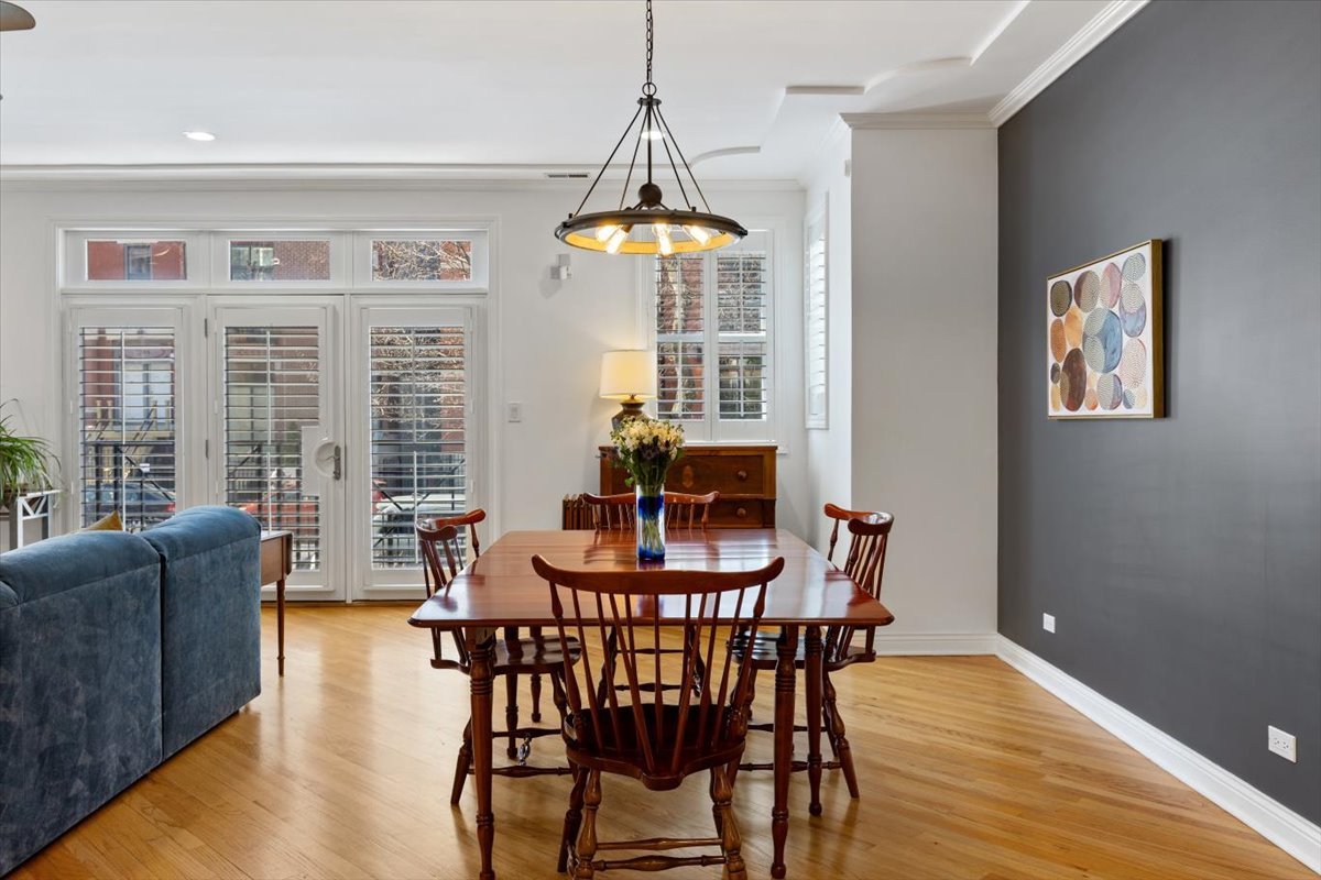 1249 North Wolcott Avenue, Unit 2 Chicago, IL 60622 - Photo 8 of 26 a dining room with furniture a chandelier and wooden floor