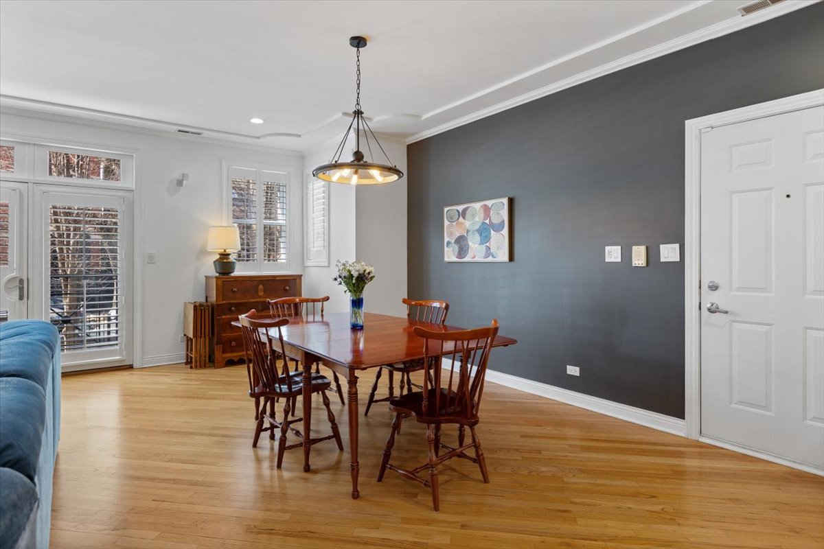 1249 North Wolcott Avenue, Unit 2 Chicago, IL 60622 - Photo 9 of 26 a view of a dining room with furniture and wooden floor