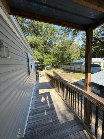 a view of balcony with wooden floor and outdoor seating