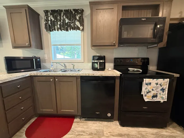 a kitchen with a sink stove and microwave