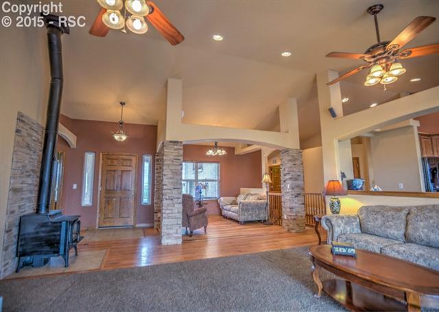 View of the entry and sitting room.  Notice the brick columns, gorgeous wood floors and the open concept through out the living areas