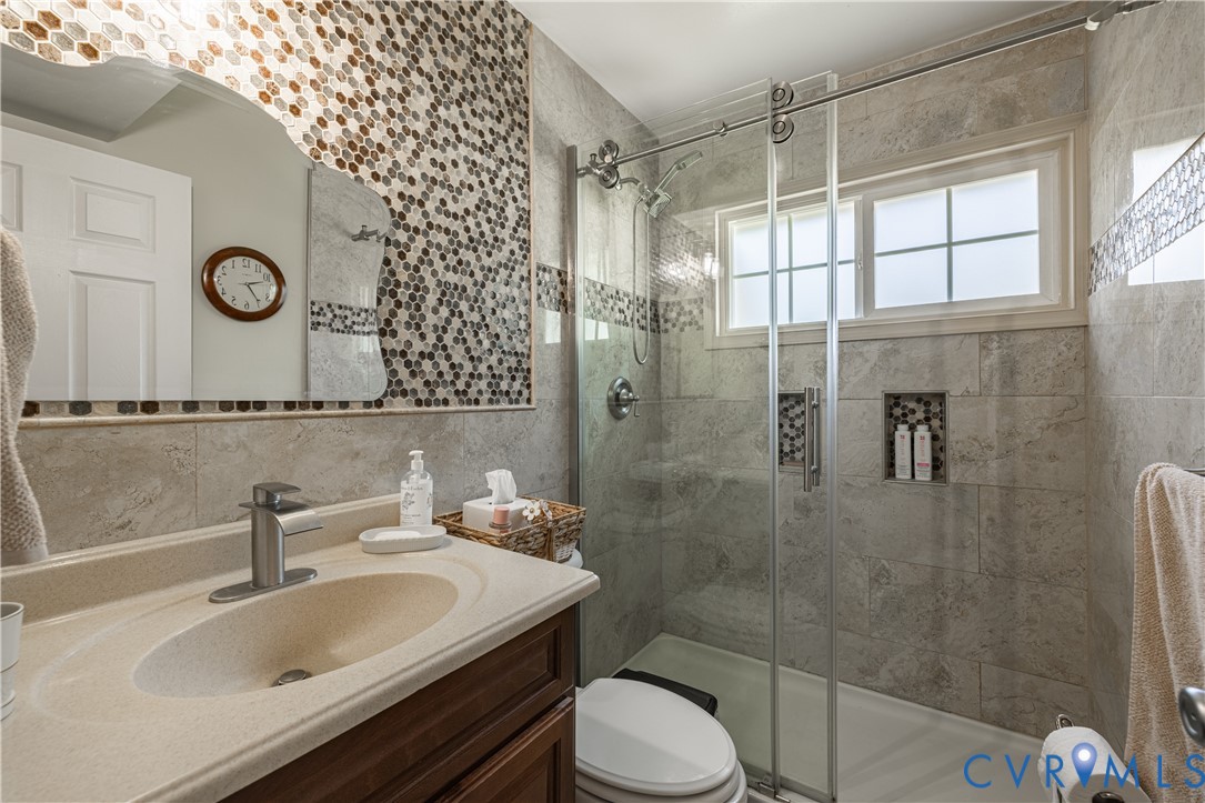 9217 Fisk Road Richmond, VA 23229 - Photo 18 of 39 a bathroom with a sink toilet and shower