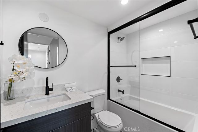 a bathroom with a toilet a sink and a mirror