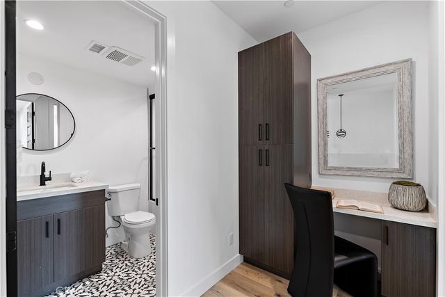 a large kitchen with stainless steel appliances granite countertop a stove and a sink with cabinets