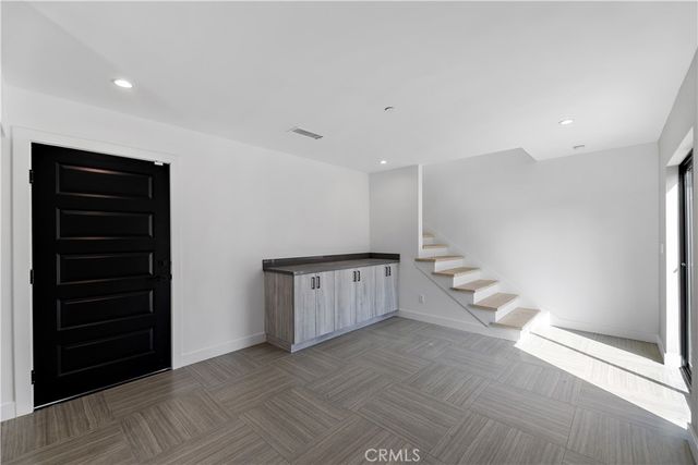 a large kitchen with stainless steel appliances granite countertop a stove and a sink