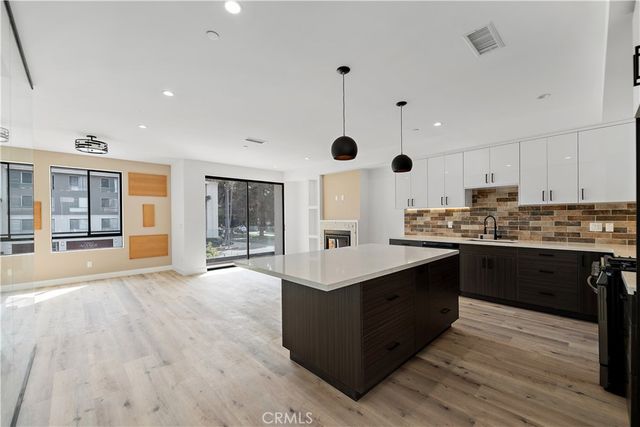 a kitchen with stainless steel appliances a stove sink and cabinets