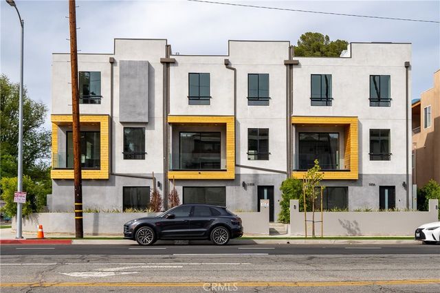 a large kitchen with kitchen island a large island in the center