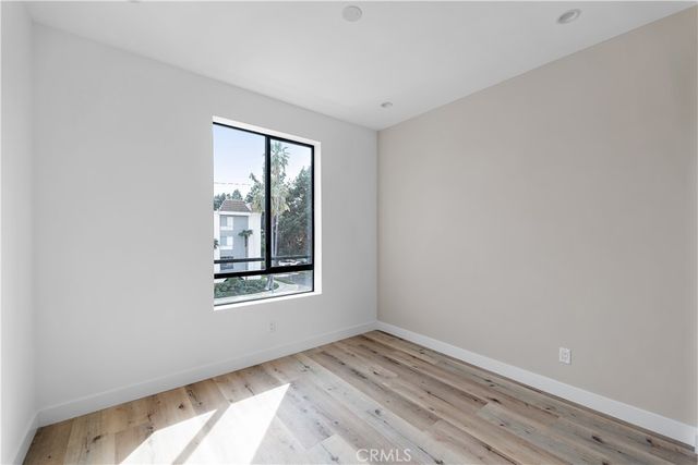 a view of a house with a small yard and potted plants