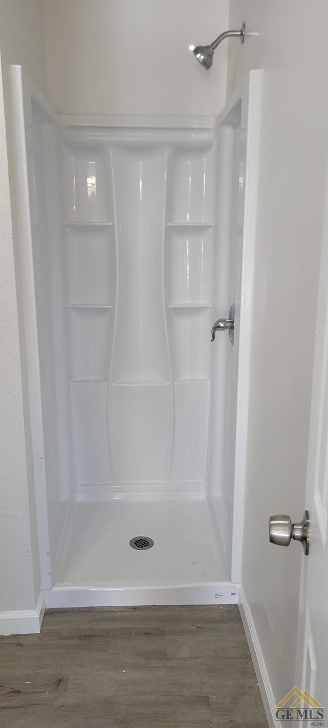 Undisclosed Address Bakersfield, CA 93308 - Photo 13 of 15 a bathroom with a glass shower door