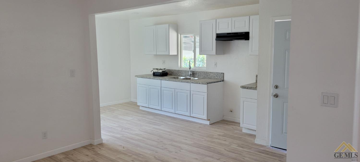 Undisclosed Address Bakersfield, CA 93308 - Photo 4 of 15 a kitchen with a sink and cabinets
