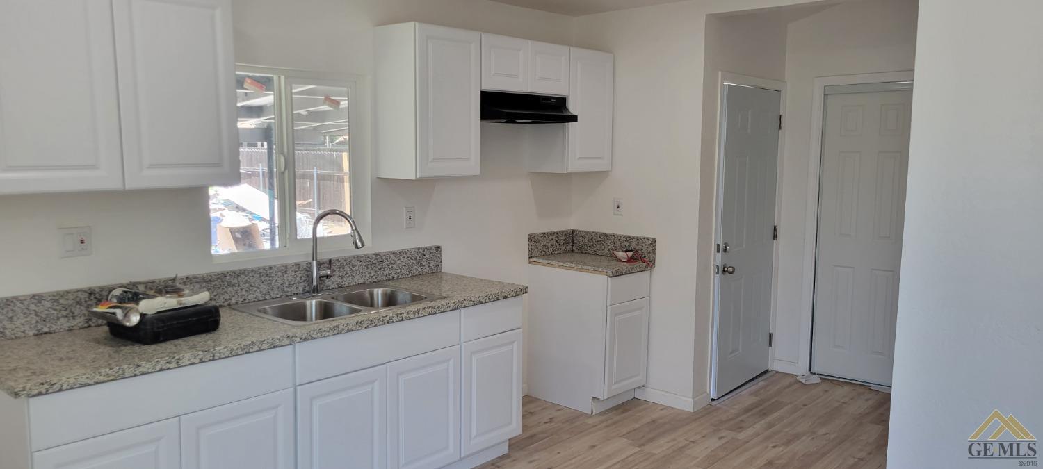 Undisclosed Address Bakersfield, CA 93308 - Photo 5 of 15 a kitchen with a sink and cabinets