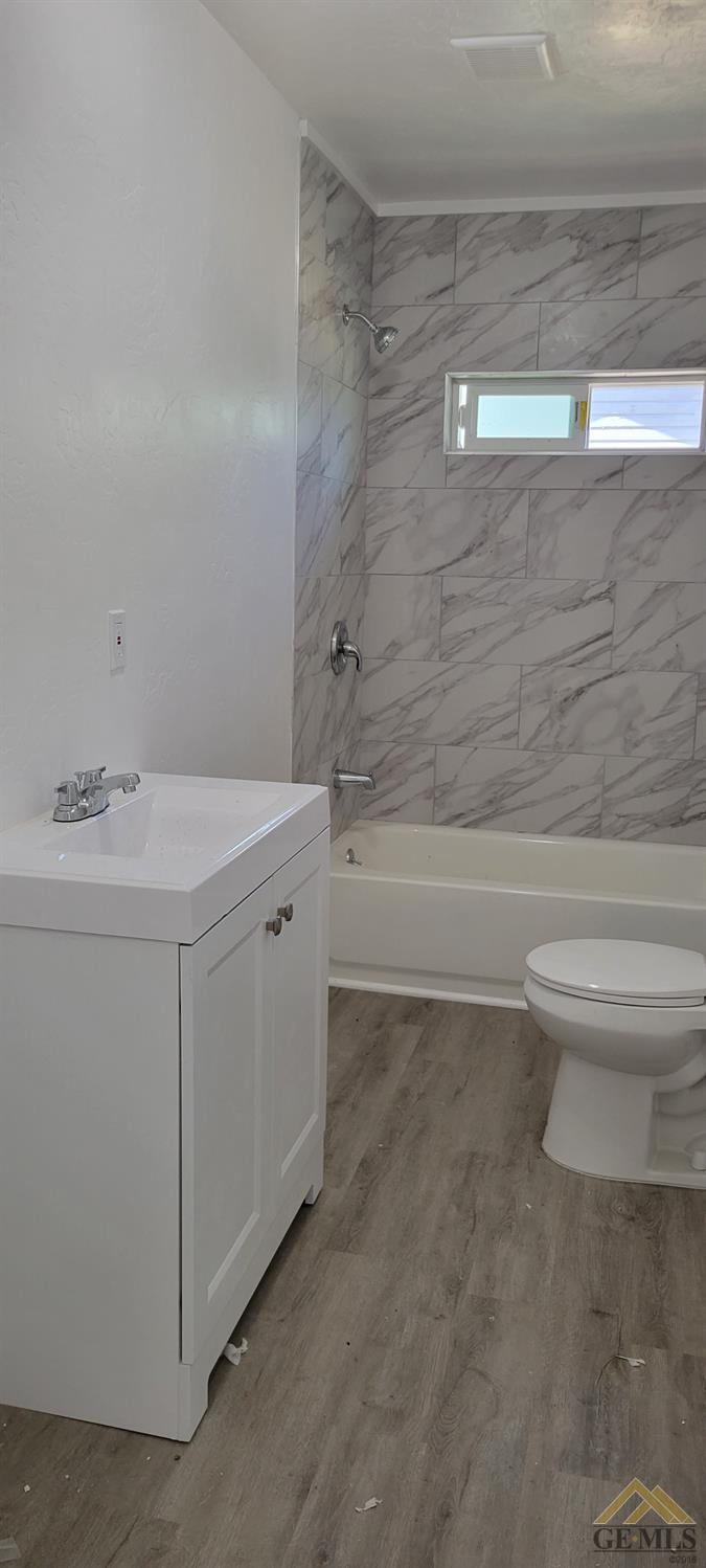 Undisclosed Address Bakersfield, CA 93308 - Photo 8 of 15 a bathroom with a sink a toilet and shower