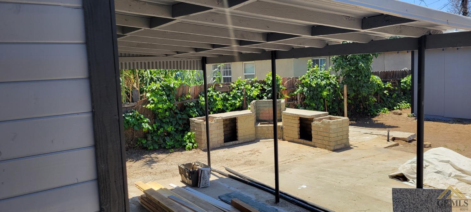 Undisclosed Address Bakersfield, CA 93308 - Photo 10 of 15 a view of a patio with table and chairs potted plants with wooden floor