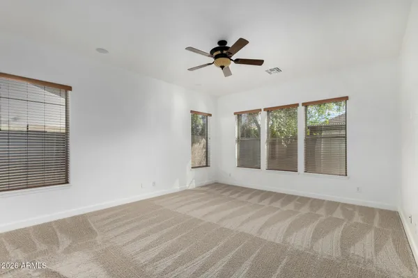 a view of a room with a ceiling fan