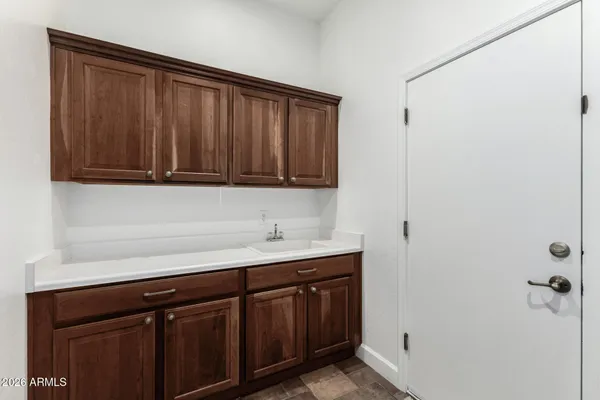 a view of storage and utility room with wooden floor