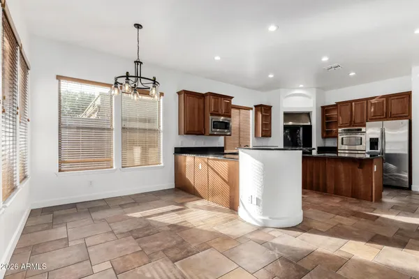a view of kitchen with sink refrigerator and microwave