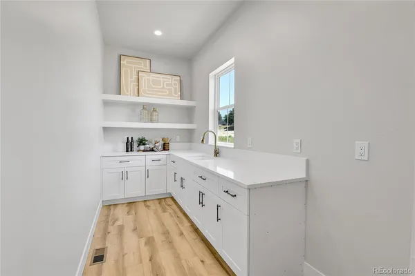 a kitchen with granite countertop white cabinets and white appliances