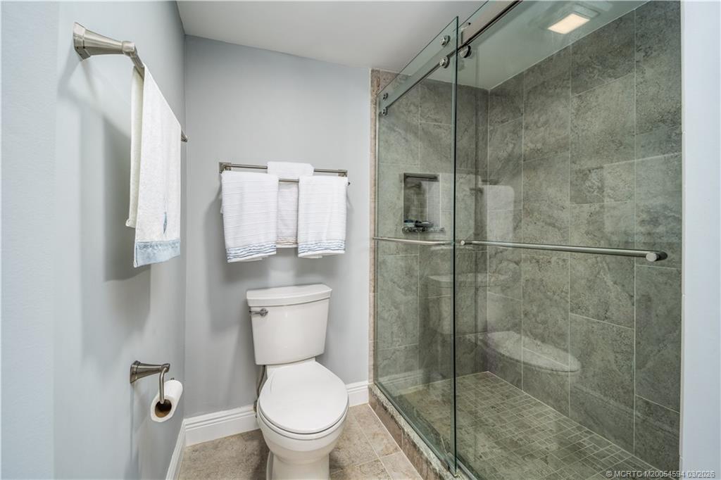 3100 Southeast Pruitt Road, Unit E203 Port St. Lucie, FL 34952 - Photo 21 of 36 Tile to the ceiling. Lovely glass doors