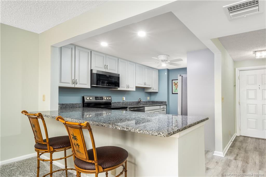 3100 Southeast Pruitt Road, Unit E203 Port St. Lucie, FL 34952 - Photo 9 of 36 Wall removed merging kitchen & living space