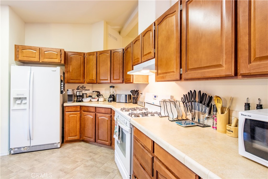 5038 Oak Road Midpines, CA 95345 - Photo 16 of 53 a kitchen with stainless steel appliances granite countertop a sink a stove and a refrigerator