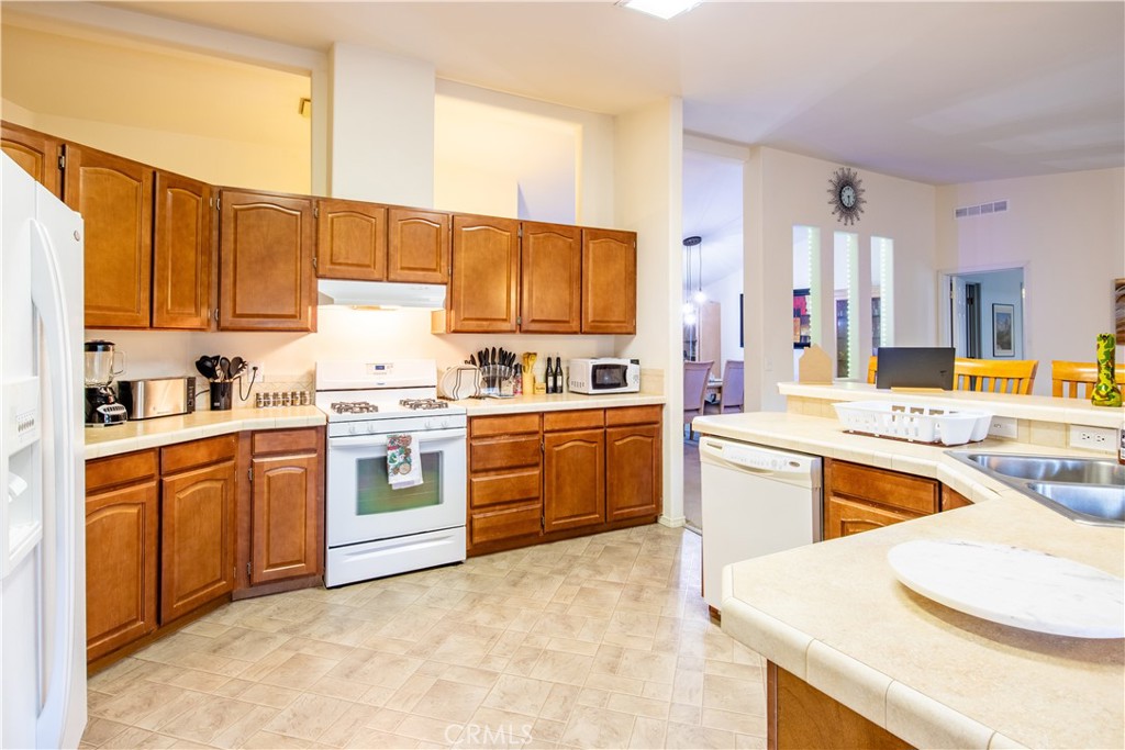 5038 Oak Road Midpines, CA 95345 - Photo 17 of 53 a kitchen with stainless steel appliances granite countertop a stove sink and cabinets