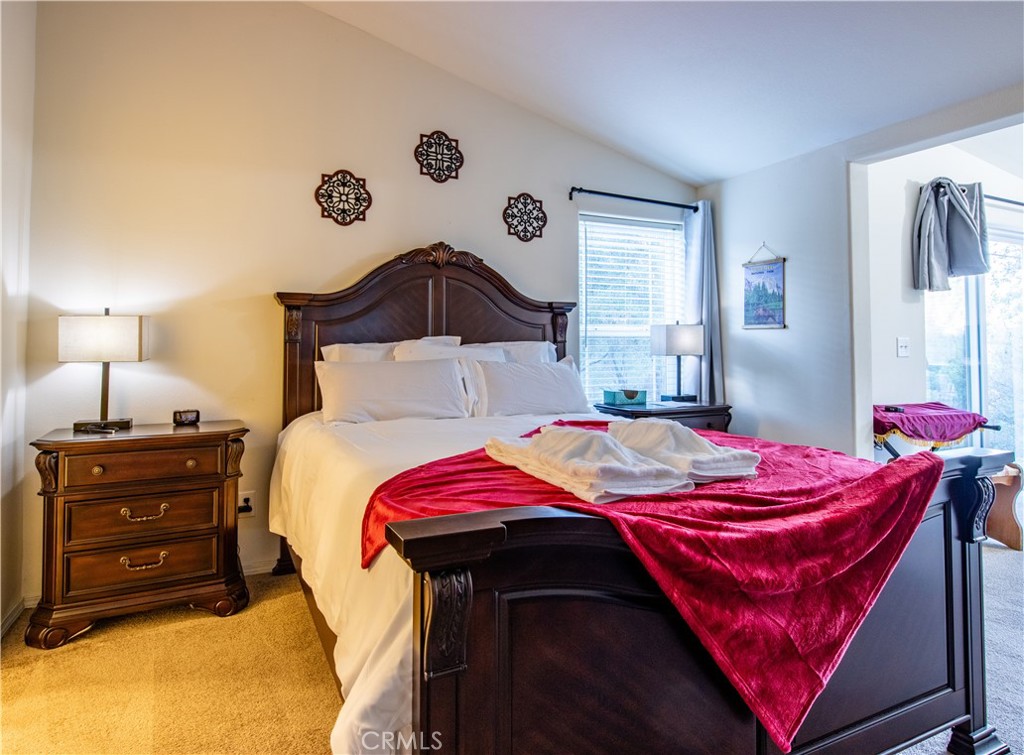 5038 Oak Road Midpines, CA 95345 - Photo 18 of 53 a bedroom with a bed and a lamp