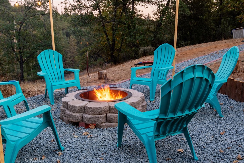 5038 Oak Road Midpines, CA 95345 - Photo 45 of 53 a view of a chairs and table in the backyard