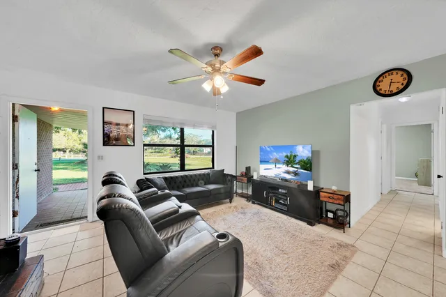 a view of a livingroom with a lounge chair and a fireplace in a room