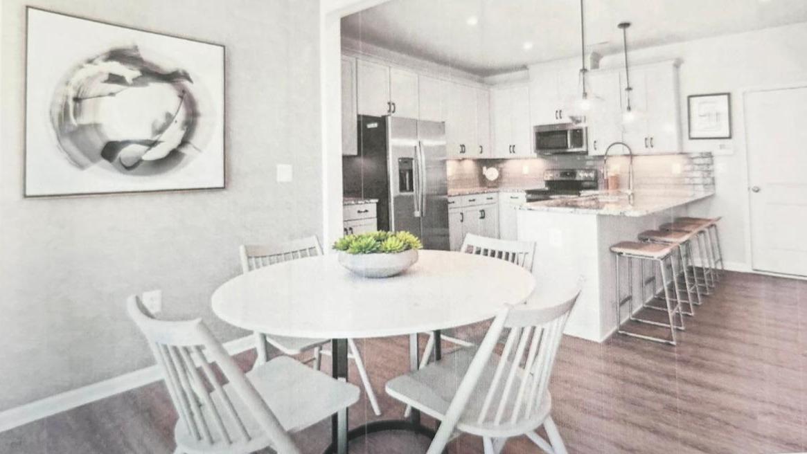 11060 Ligon Mill Road, Unit 100 Wake Forest, NC 27587 - Photo 2 of 3 a view of a dining room with furniture and wooden floor