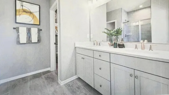 a bathroom with a double vanity sink and mirror