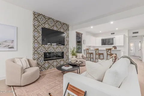 a living room with furniture a fireplace and a flat screen tv