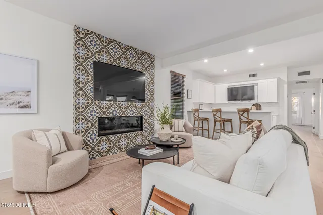 a living room with furniture a fireplace and a flat screen tv