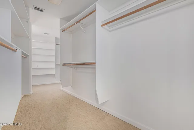 a room with painting and a vase of flowers