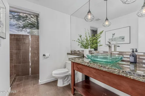 an empty room with a window and a ceiling fan