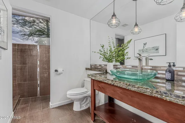 an empty room with a window and a ceiling fan