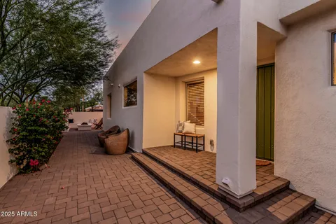 a backyard of a house with table and chairs