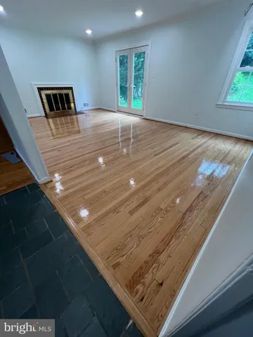 a view of kitchen and hall with wooden floor