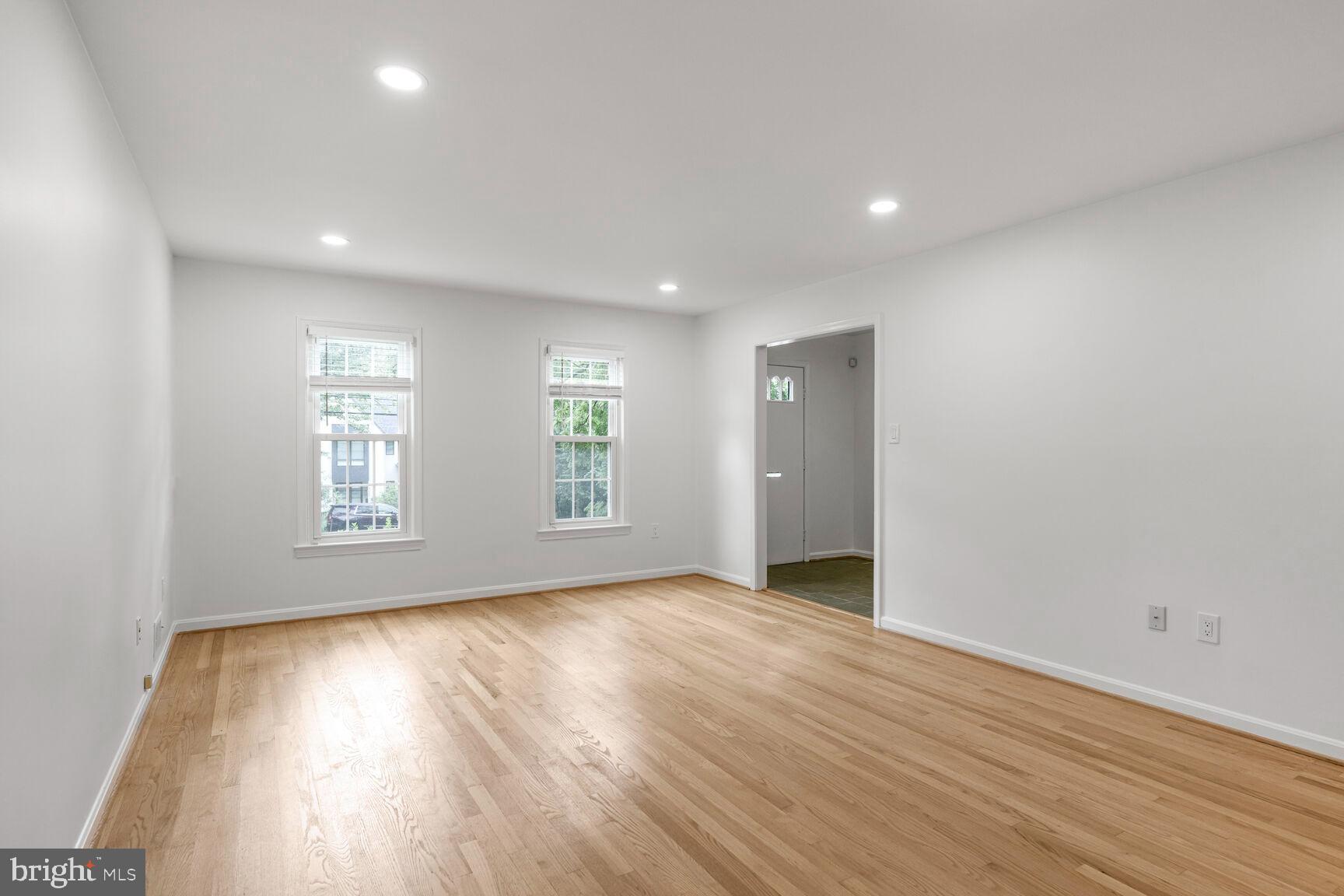 9102 Jones Mill Road Chevy Chase, MD 20815 - Photo 12 of 32 an empty room with wooden floor and windows