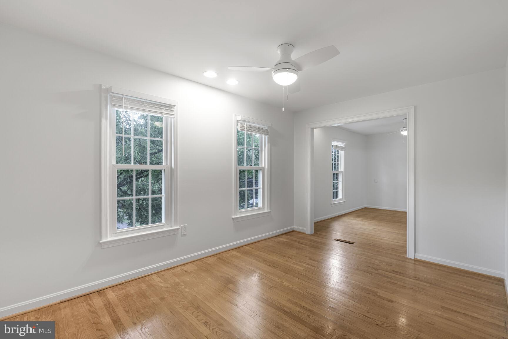9102 Jones Mill Road Chevy Chase, MD 20815 - Photo 17 of 32 a view of an empty room with wooden floor and a window