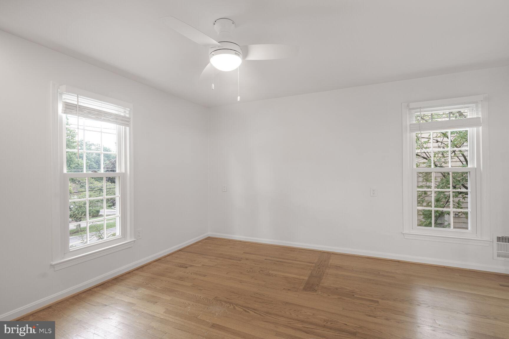 9102 Jones Mill Road Chevy Chase, MD 20815 - Photo 18 of 32 wooden floor in an empty room with a window