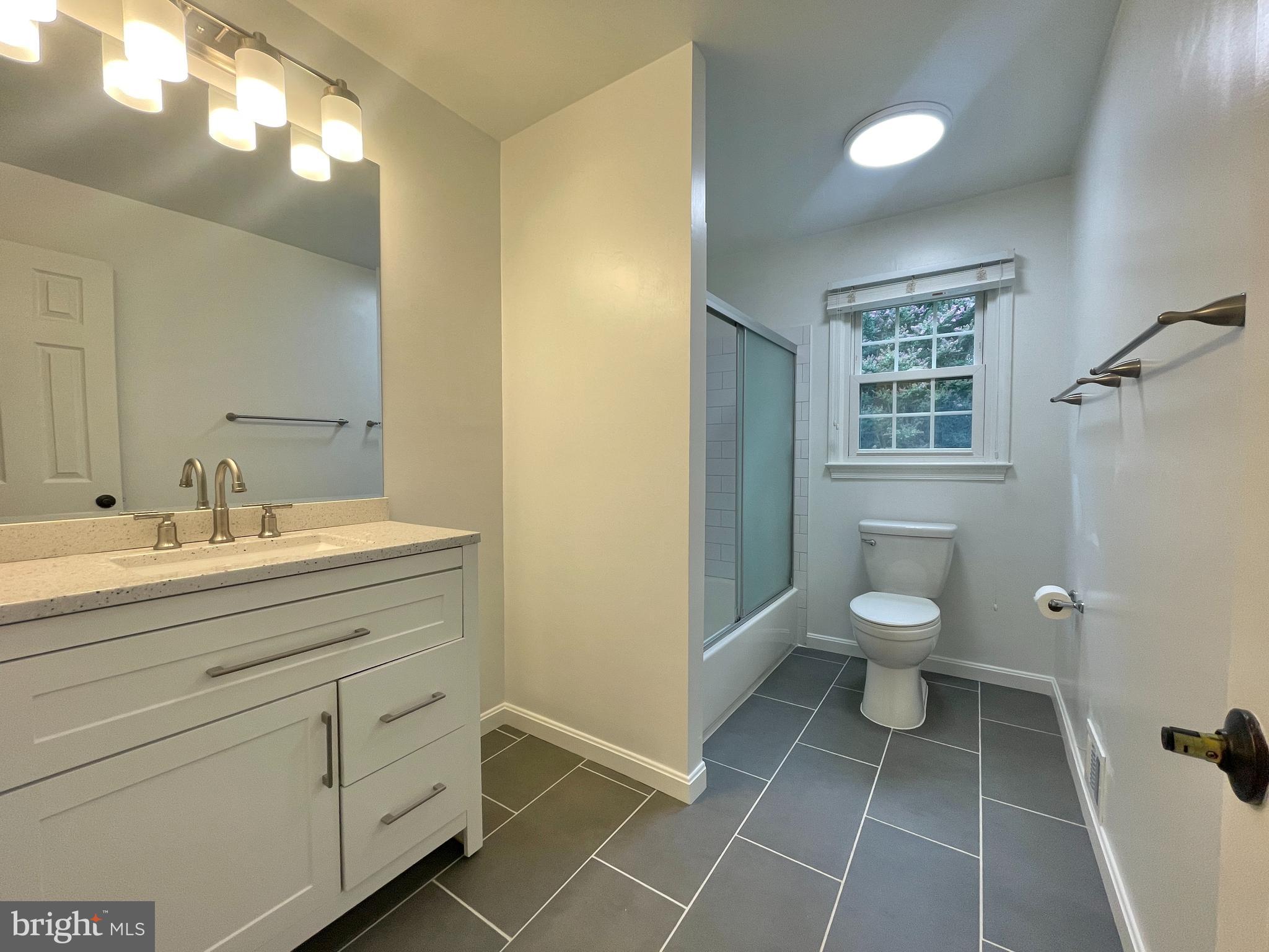 9102 Jones Mill Road Chevy Chase, MD 20815 - Photo 24 of 32 a bathroom with a toilet sink and a mirror