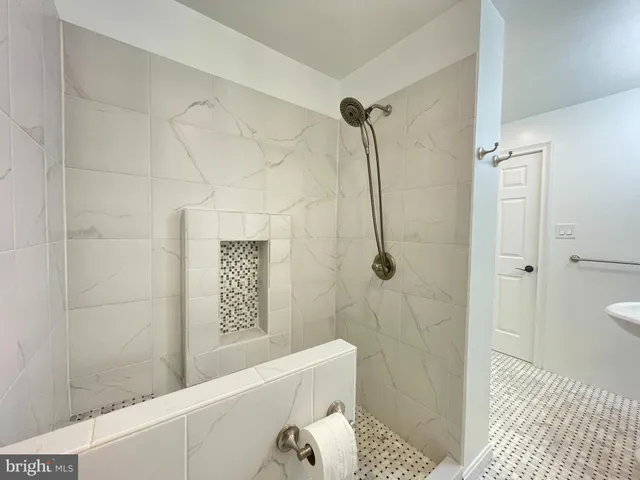 a bathroom with a bathtub and shower