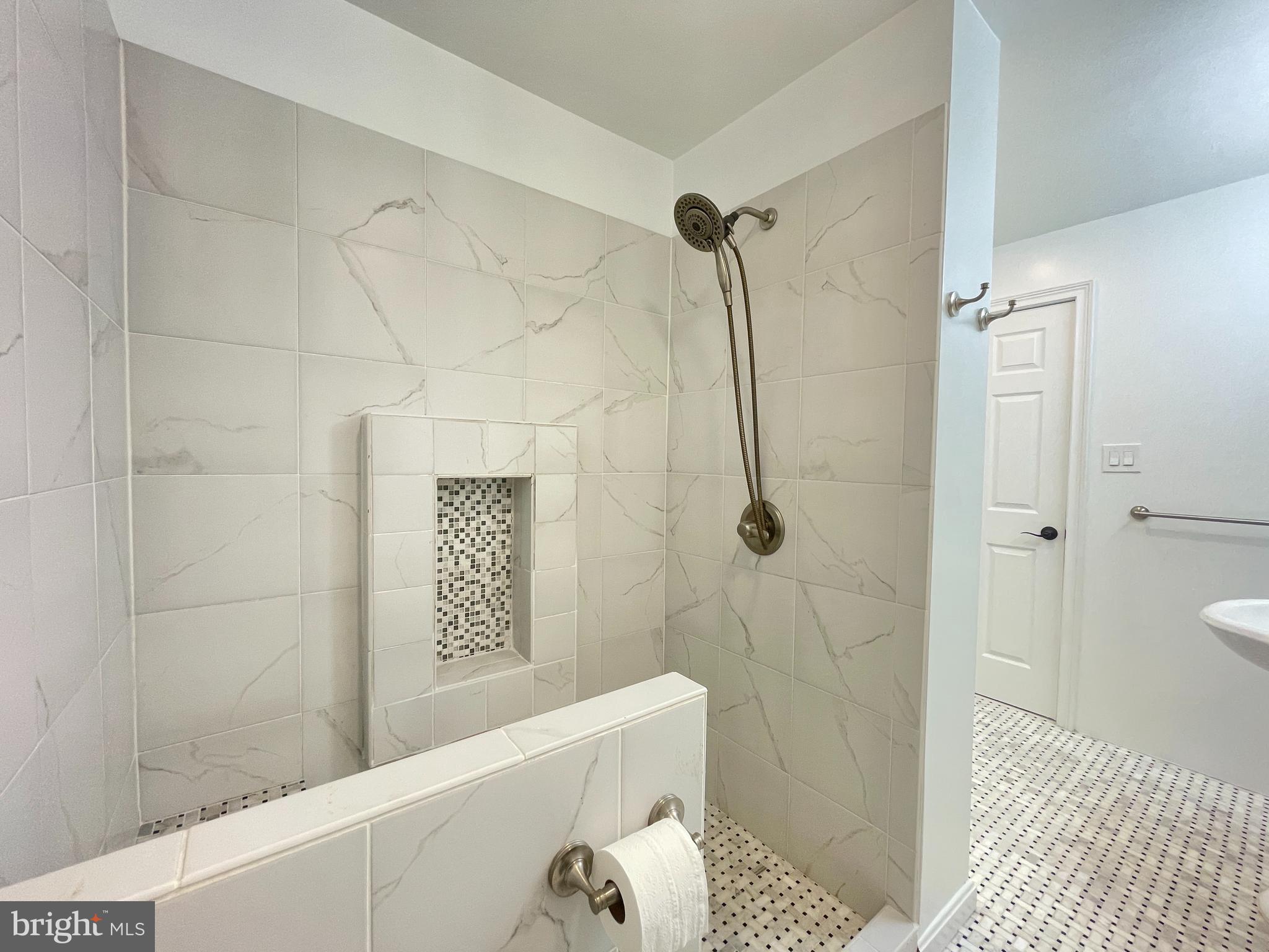 9102 Jones Mill Road Chevy Chase, MD 20815 - Photo 27 of 32 a bathroom with a bathtub and shower