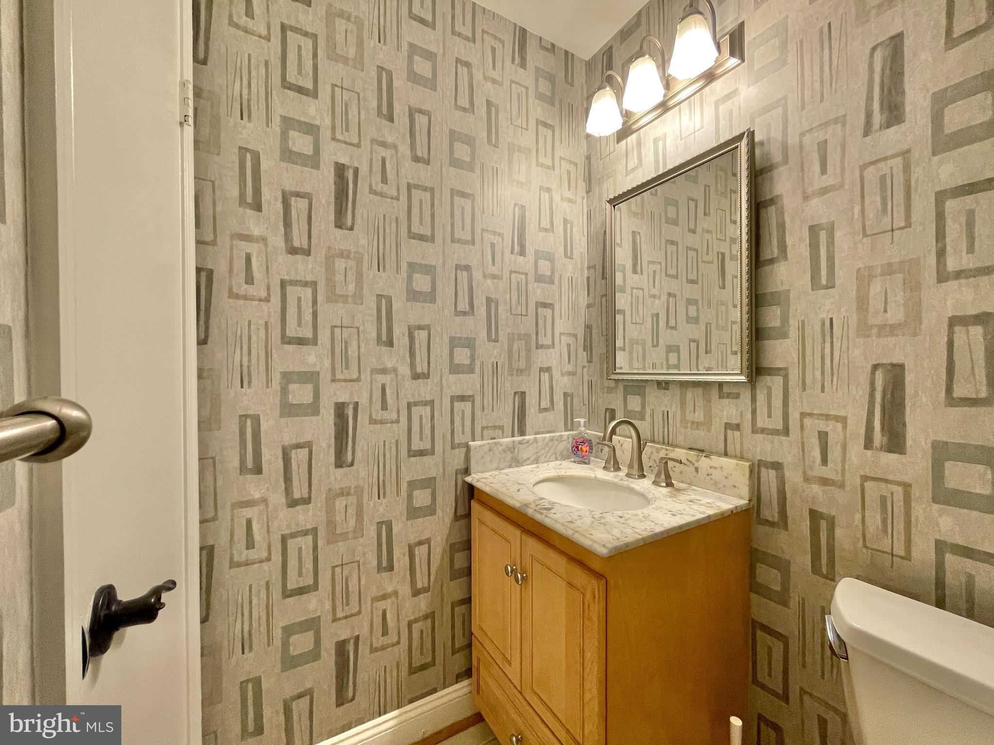 9102 Jones Mill Road Chevy Chase, MD 20815 - Photo 28 of 32 a bathroom with a sink and a mirror