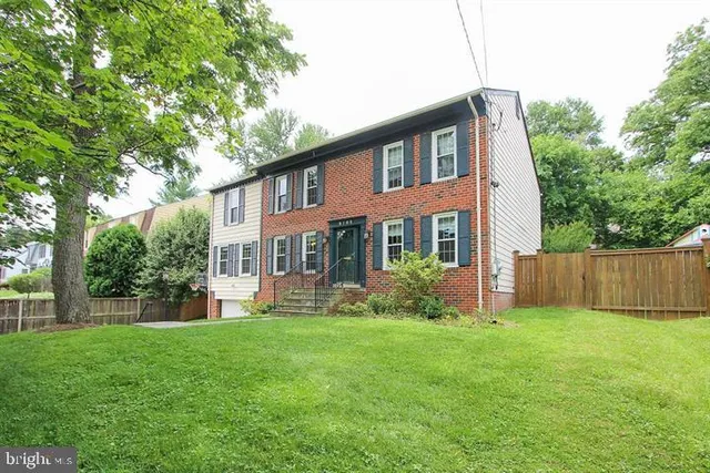 a view of a house with a yard and plants