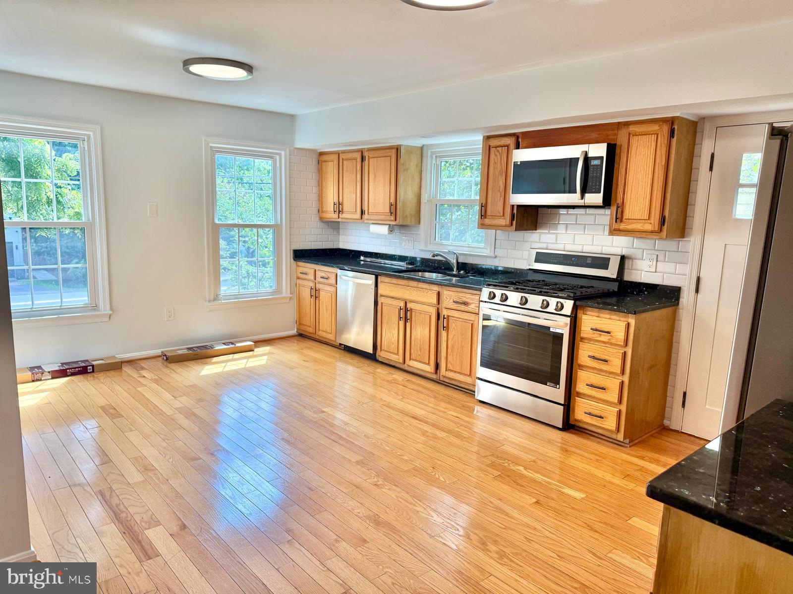 9102 Jones Mill Road Chevy Chase, MD 20815 - Photo 5 of 32 a kitchen with stainless steel appliances granite countertop a stove a sink and a microwave